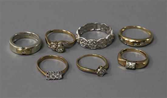 Seven assorted 9ct gold diamond set dress rings.